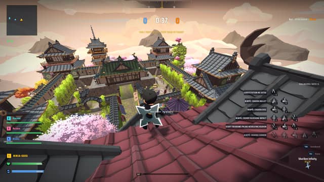 A ninja crouched on a tiled rooftop above the NinjaPVP village, pagodas and cherry blossoms below during a Team Deathmatch round
